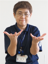 手話通訳者・鈴木さんが「グー」にした手を「パー」に開いた写真