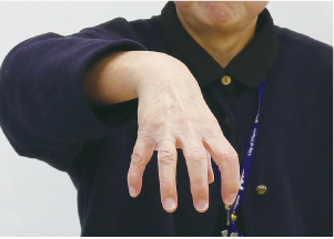 手話通訳者・鈴木さんが手の平を丸くして下向きにしている写真