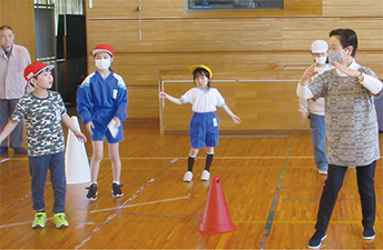 小須戸小学校の児童が「小須戸甚句・樽太鼓」を地域の名人たちから教わる様子を撮った写真