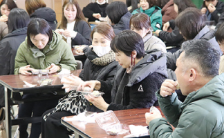 保護者の皆さんがもち麦おにぎりを試食している写真