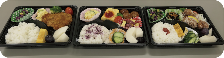 ５年生が考えた南区の特産品「かきのもと」「梨」を入れたお弁当３種類の写真
