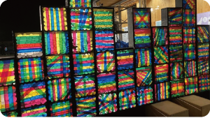 カラフルな光を放つ箱がいくつも重なったオブジェの写真