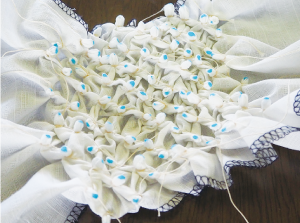 鹿の子絞りを染める前の布の写真。細かく布を糸で縛り1センチくらいの粒をたくさん作っています。