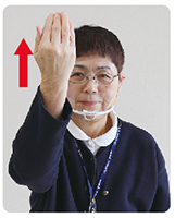 手話通訳者・鈴木さんが内側にした手を上に上げている写真